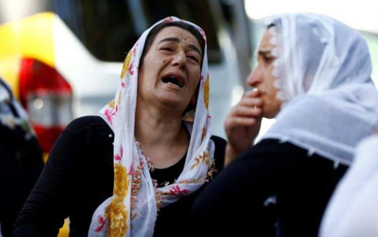 Women mourn as they wait in front of a hospital morgue in the Turkish city of Gaziantep, after a suspected bomber targeted a wedding celebration in the city, Turkey, August 21, 2016.