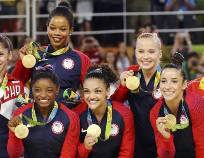 Simone Biles, Gabrielle Douglas, Laurie Hernandez, Aly Raisman, and Madison Kochian pose with their gold medals.