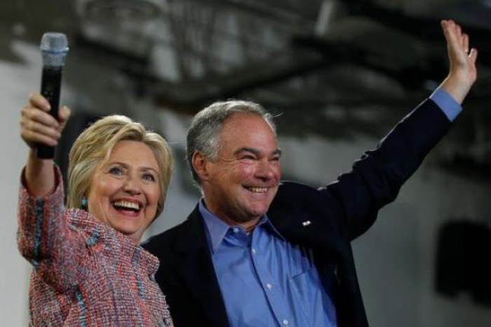 Democratic U.S. presidential candidate Hillary Clinton and U.S. Senator Tim Kaine (D-VA) wave to the crowd during a campaign rally at Ernst Community Cultural Center in Annandale, Virginia, U.S., July 14, 2016. REUTERS/Carlos Barria