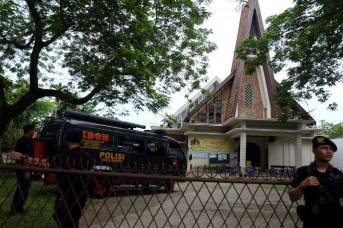Police are seen outside Saint Joseph catholic church after a suspected terror attack by a knife-wielding assailant on a priest during the Sunday service in Medan, North Sumatra, Indonesia August 28, 2016 in this photo taken by Antara Foto.