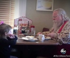 An Adorable Little Girl Won't Let Santa Eat Breakfast Alone