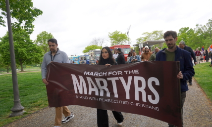 'Ask God for their protection': Demonstrators march through the rain to stand with persecuted Christians