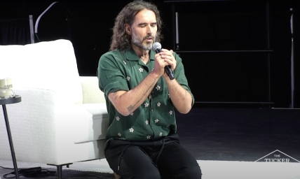 Russell Brand kneels in prayer at Tucker Carlson event, prays against 'dark and demonic forces'