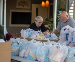 ‘This is love in motion’: Church gives away groceries to 400 families in need