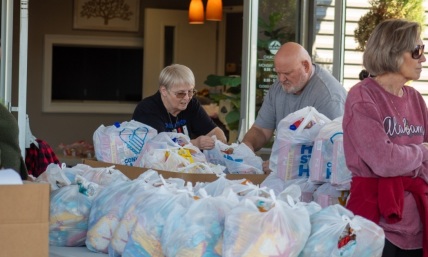 ‘This is love in motion’: Church gives away groceries to 400 families in need