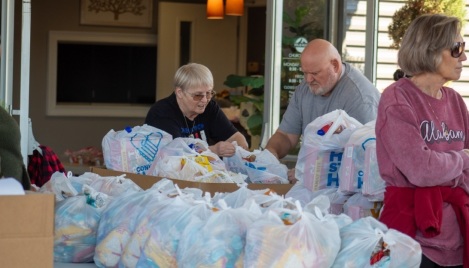 ‘This is love in motion’: Church gives away groceries to 400 families in need