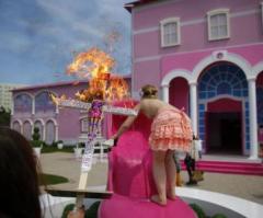Barbie Burns on Cross at Berlin Protest of Barbie Dreamhouse Opening
